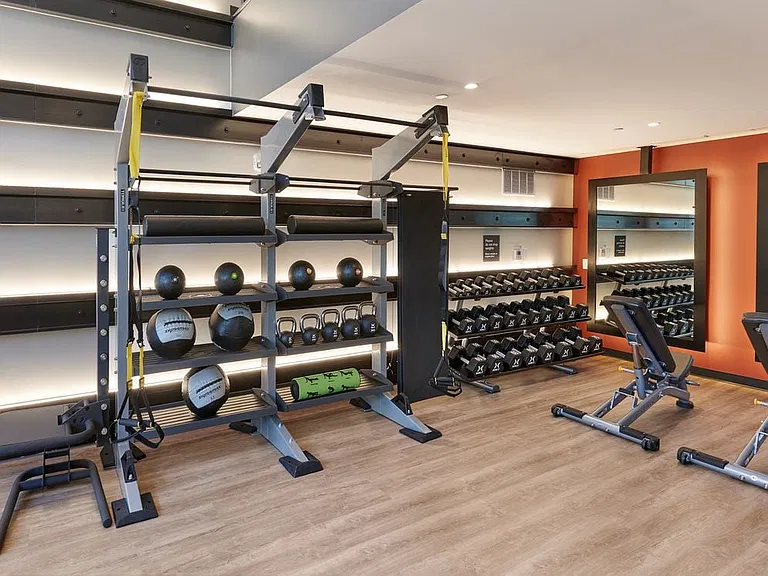 Upper level fitness center with squat rack and other weight machines
