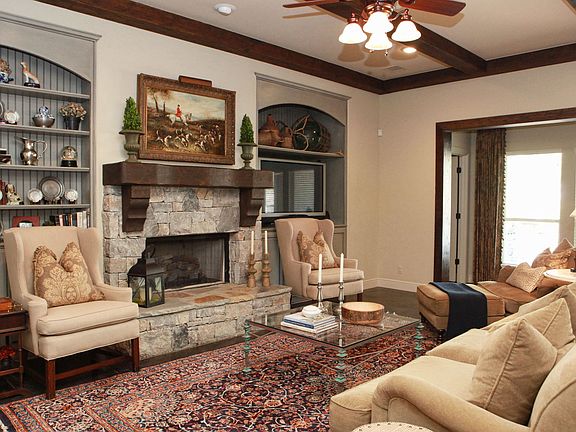 Spacious Living Room with stacked stone fireplace and built-in bookcases