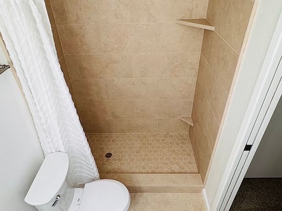 New tile. New shower hardware. Foot shelf for shaving. New toilet. New titled floor!