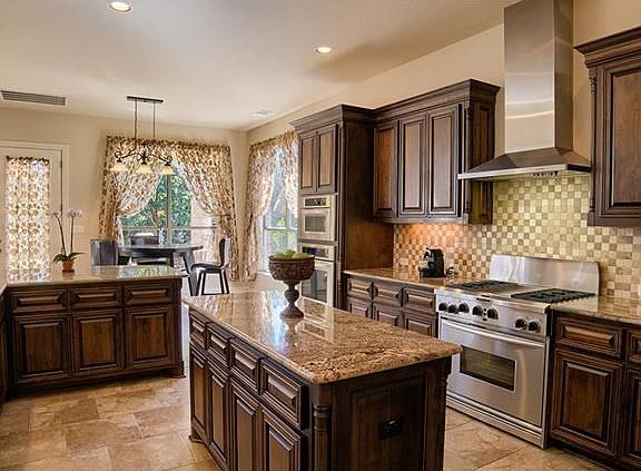Truly uncompromising state-of-the-art kitchen! Features a large center island, custom backsplash and