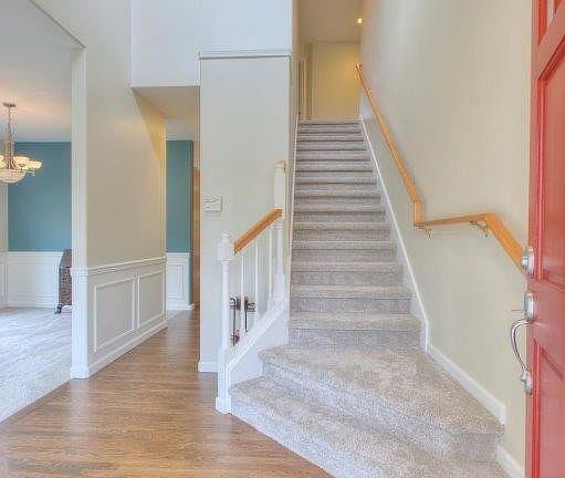 Beautifully re-finished hardwoods greet and extend thru the kitchen and informal dining room!  New carpet throughout!