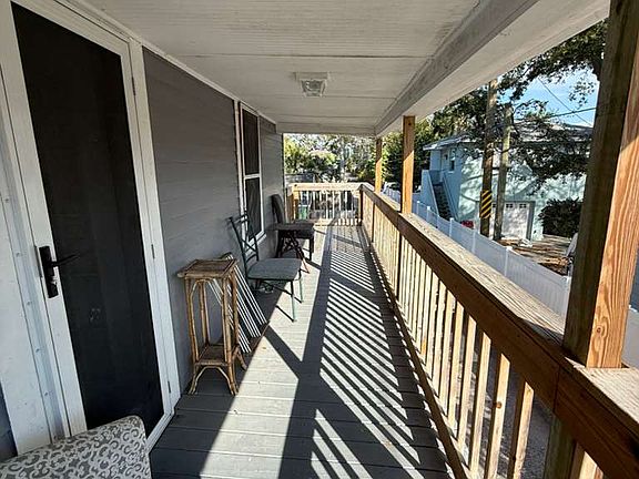 Porch with sunrise view and view of Sunken Garden