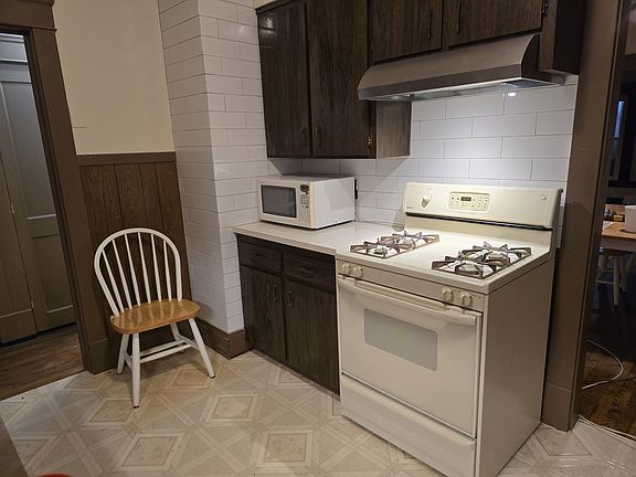 Kitchen has new subway tile backsplash and exterior exhaust fan.