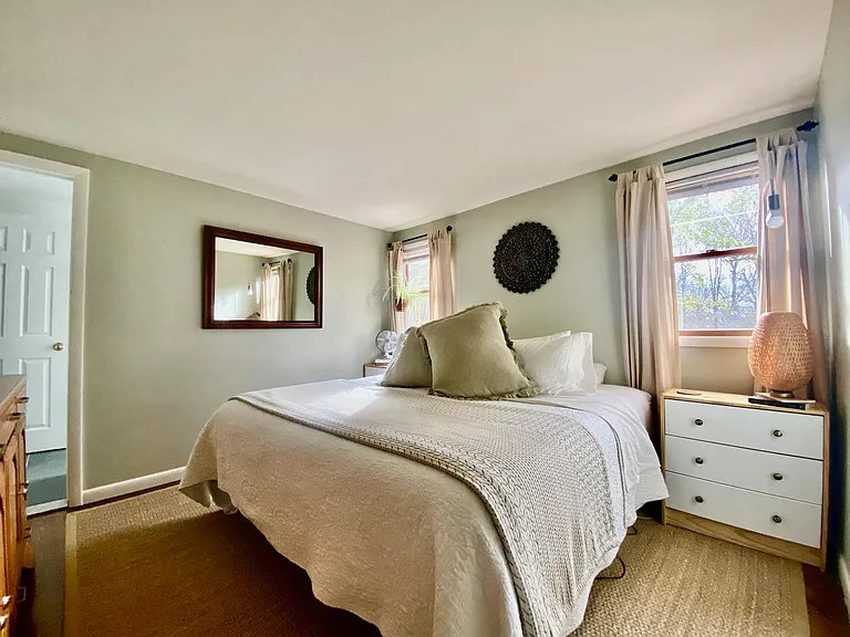 Serene master bedroom with hardwood floors, overlooking back field, connected to luxe master bath.