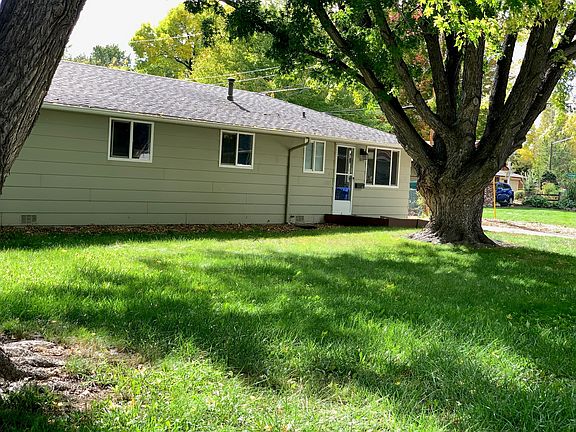 Front of home with trees.