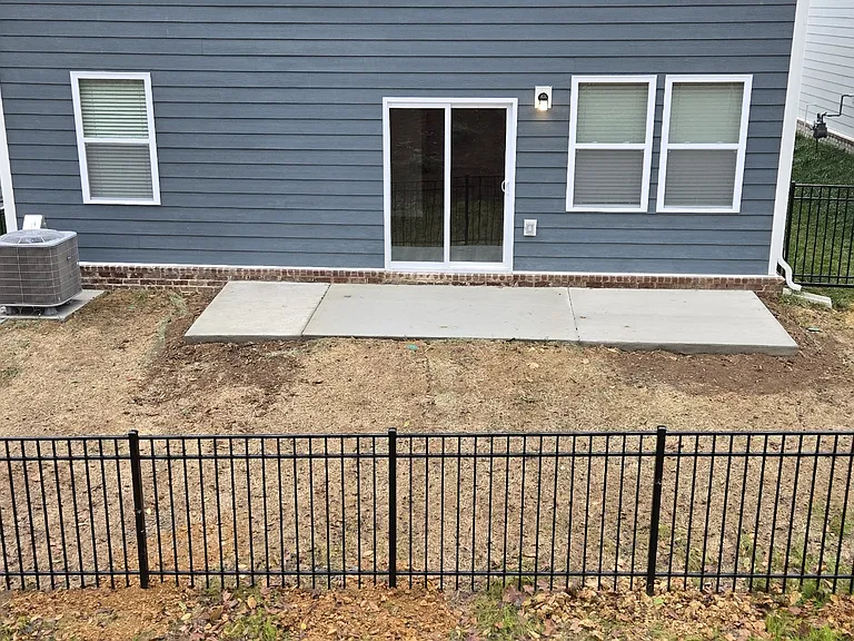 Spacious backyard with a fence.