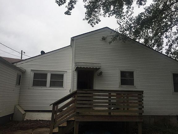 Back of house with great deck and storage building