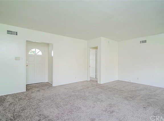 Front door, hall to bedrooms on right and living room
