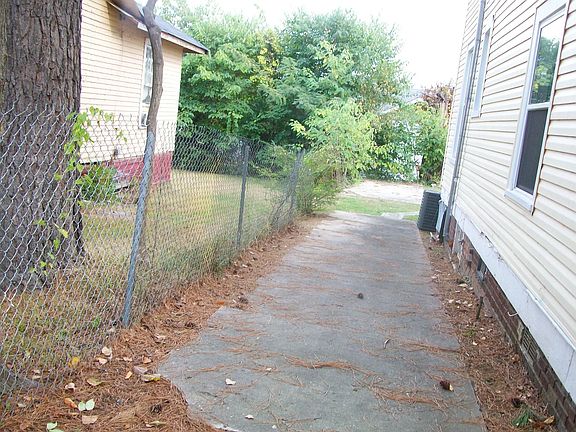 Down left side of the house, facing it from the front