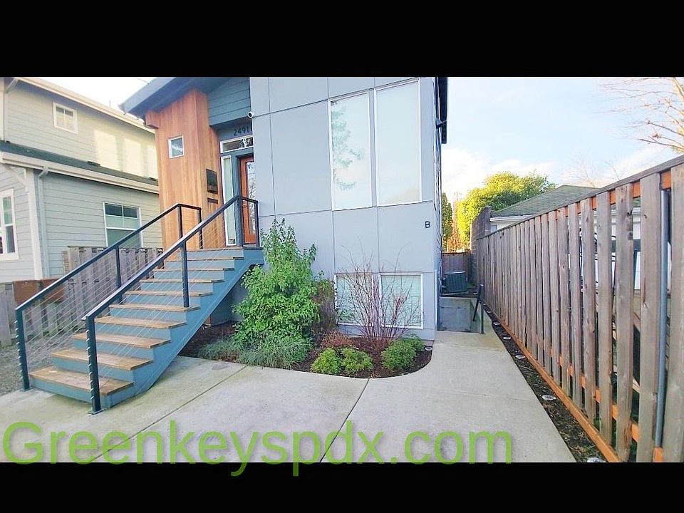 Exterior of house showing the concrete stairwell to the right that leads down to the 1-bedroom ADU.