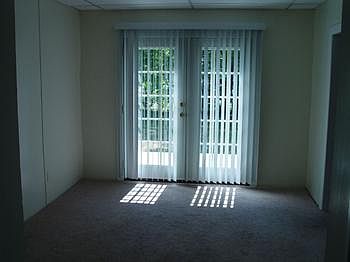 This could be a dining room or living room. It has french doors out to the deck and backyard.