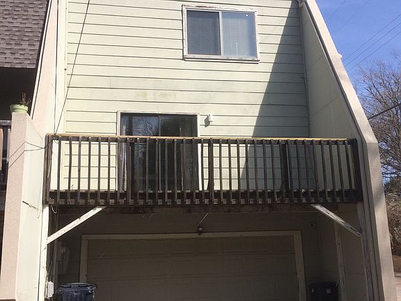 Back of Condo with Garage & Deck