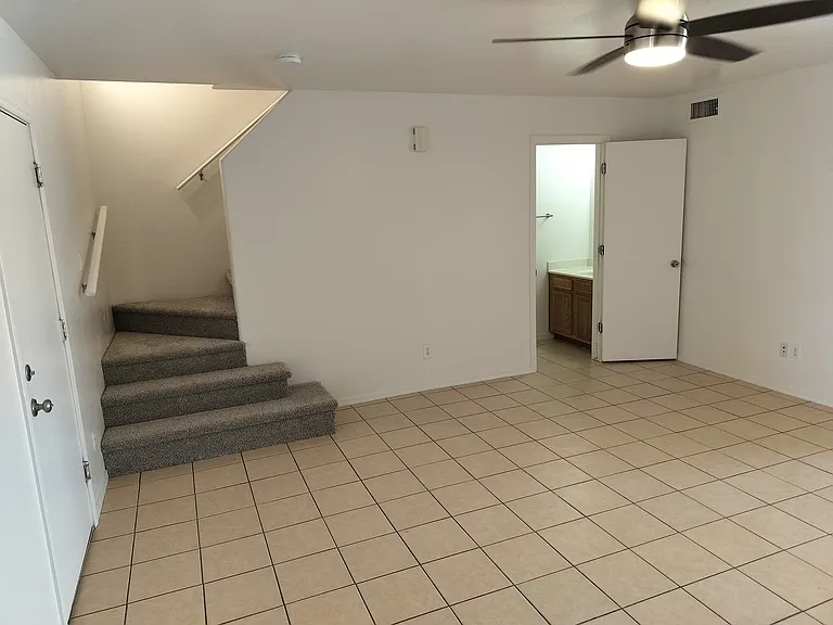 Living room with door to garage and upstairs