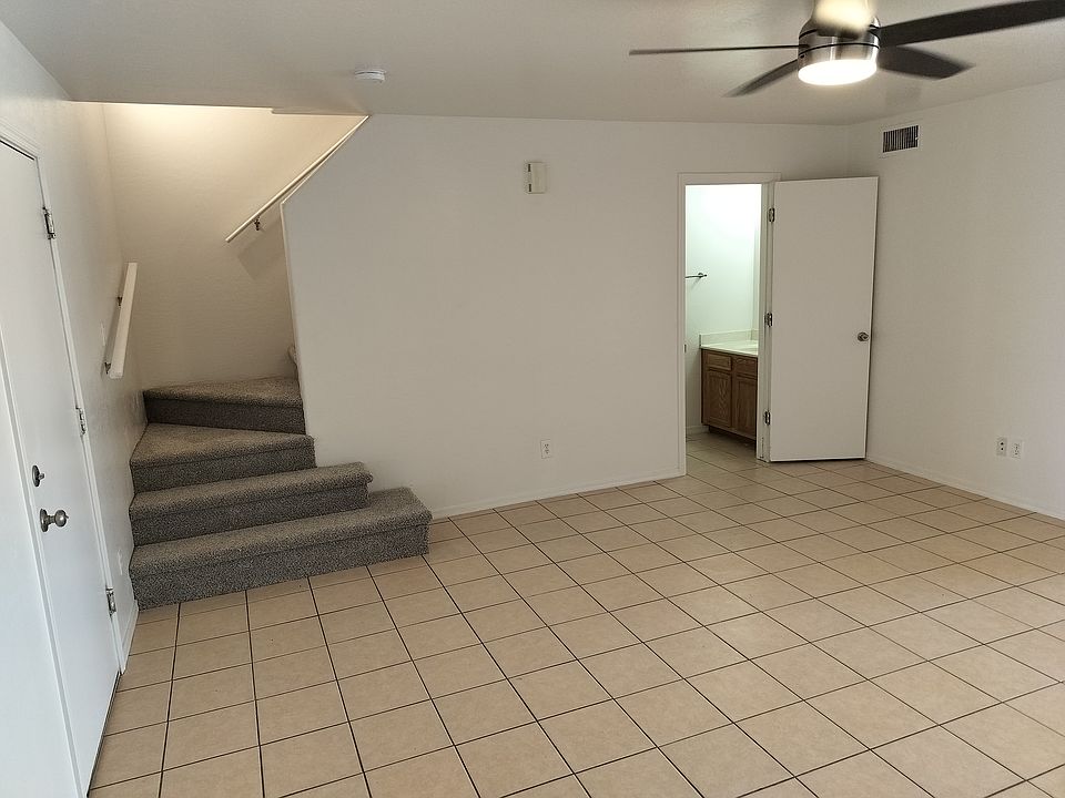 Living room with door to garage and upstairs