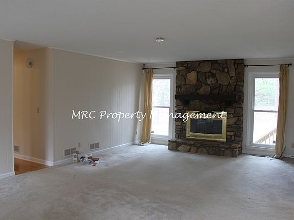 Stone Fireplace in Living Room with Lots of Daylight