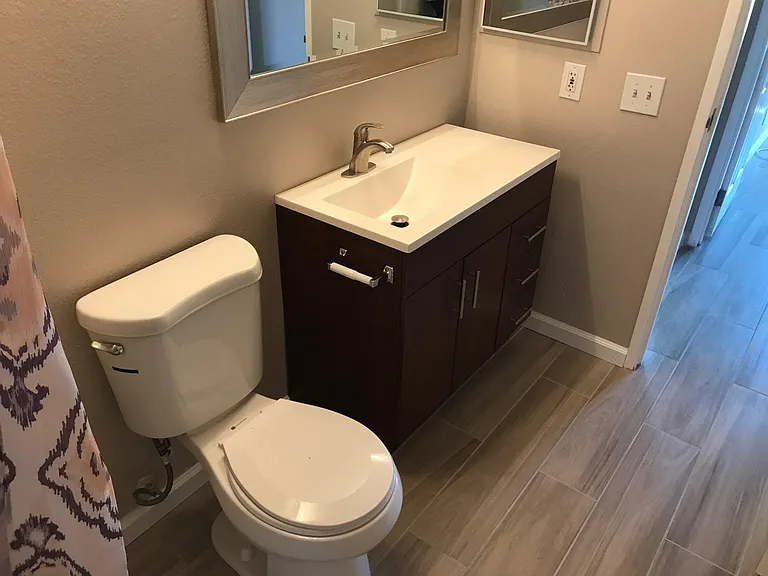 Guest bath with decorator curtain.