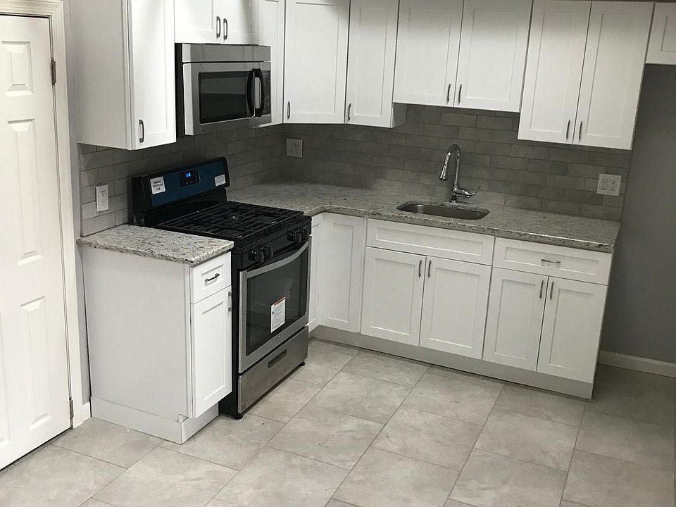 Renovated Kitchen with vaulted ceilings, skylight windows, and new appliances, plenty of space for table