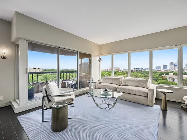 A bright sitting area with picture-window views and direct access to the private balcony.