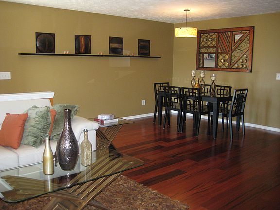 The dining room is spacious with beautiful lighting fixture.
