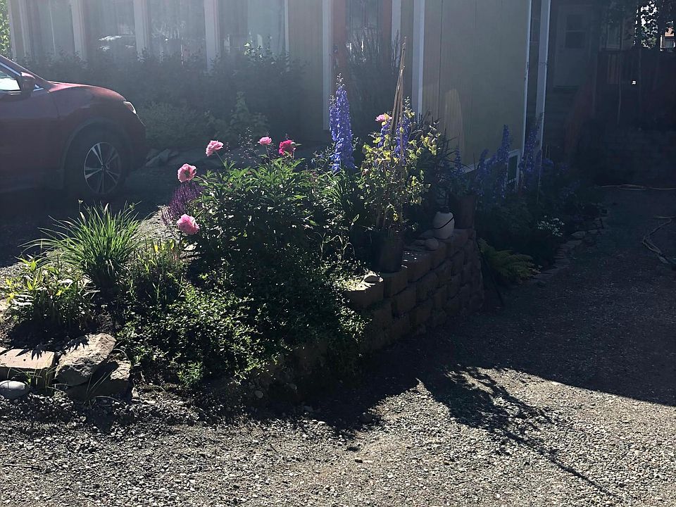 Front Access, small flower garden with privacy hedges.