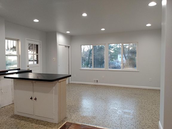 Newly renovated, bright family room, adjacent to kitchen, overlooking backyard.