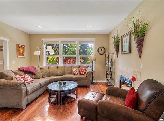 Living room with great natural light has hardwood floors throughout