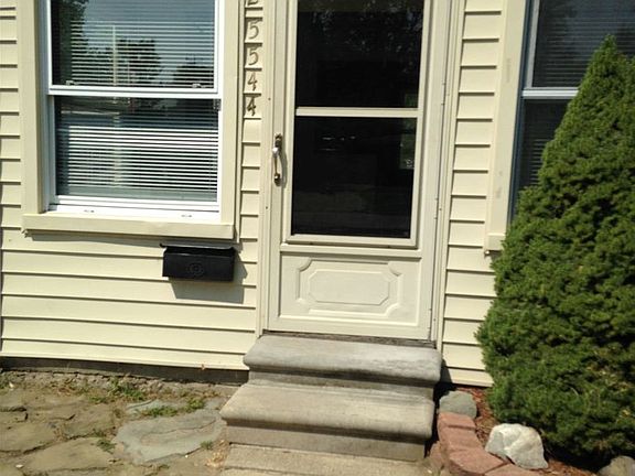 front of house with mailbox under window