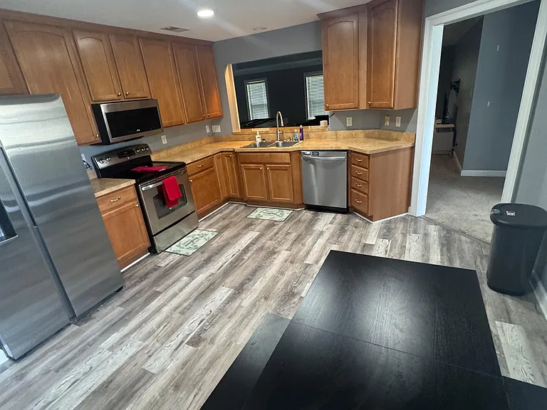 U-shaped kitchen with ample wood cabinetry, generous counter space, and stainless steel appliances for everyday cooking.