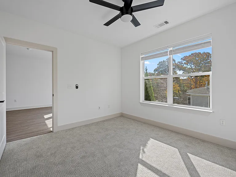Spacious Bedroom with Ceiling Fan and Connecting Room Access