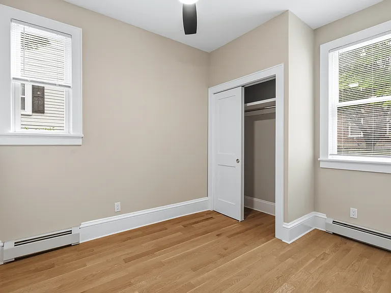 The second bedroom is a cozy space with plenty of natural light, storage, and can also be used as an office.