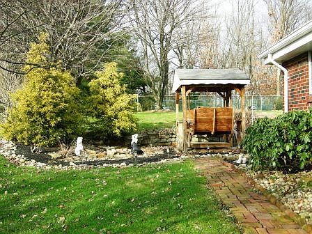 Side & back yard is a parklike setting.