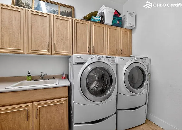 Laundry room between guest powder room and garage