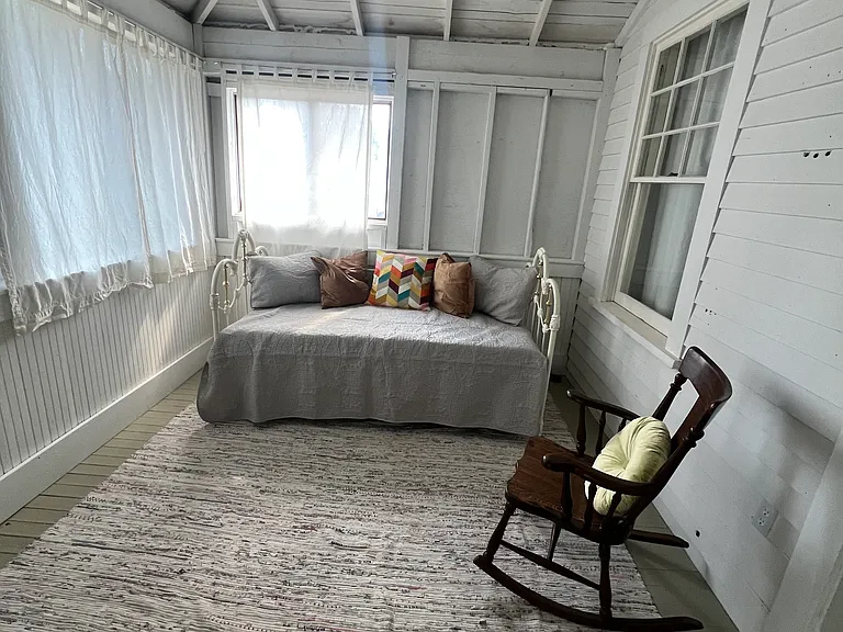 There's an uninsulated sunroom off of the second bedroom. It has a daybed and trundle bed.