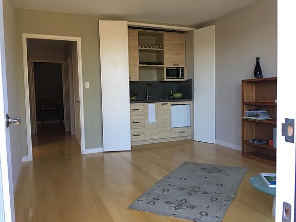 Living room, kitchenette with open doors.