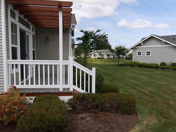 Back porch and just behind home is huge park area, clubhouse, extra parking and more.