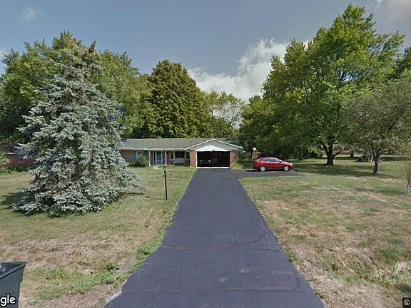 View of the front yard and driveway with additional parking spaces.