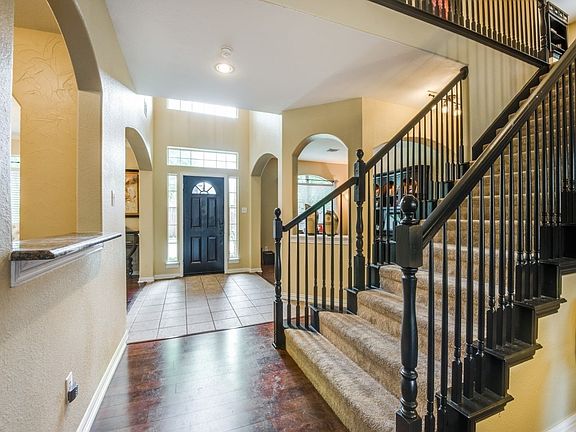 New front door with tiled into leading to faux wood floors for an updated look.