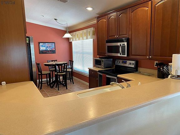 Fully equipped kitchen with additional dining area.