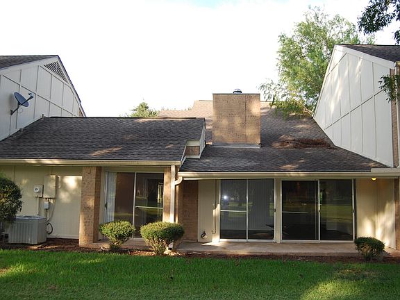 Back view of bedroom on left and TV room on right; great place to watch sports and open sliders for more outdoor space