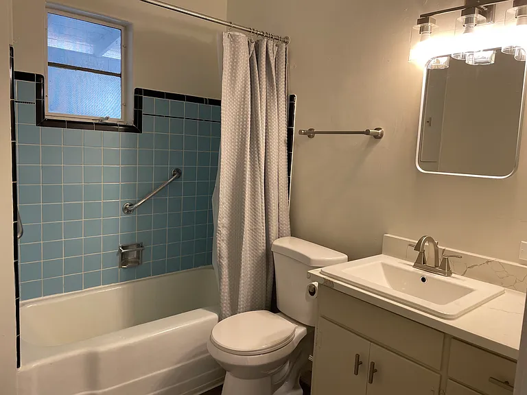 New bathroom with original tile in rub area. new Quartz countertops.