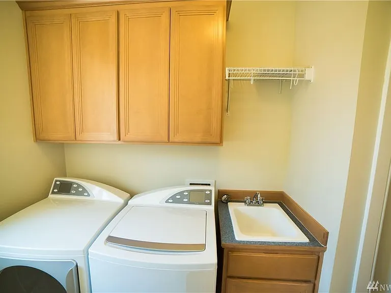 Laundry with plenty of storage and linen closet