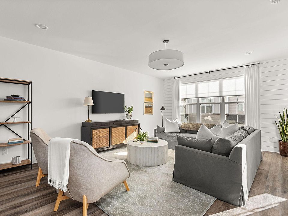 Spacious living room, TV mount, custom linen window treatments, and hardware included