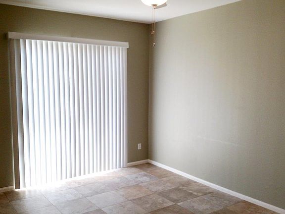 living room with sliding glass doors to front patio (walls being painted back to white)