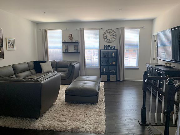 2nd floor open concept includes living room with leather furniture and smart box tv. Also half bathroom