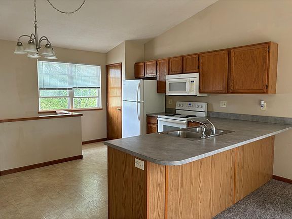 Kitchen with pantry closet, fridge, microwave, dishwasher, stove