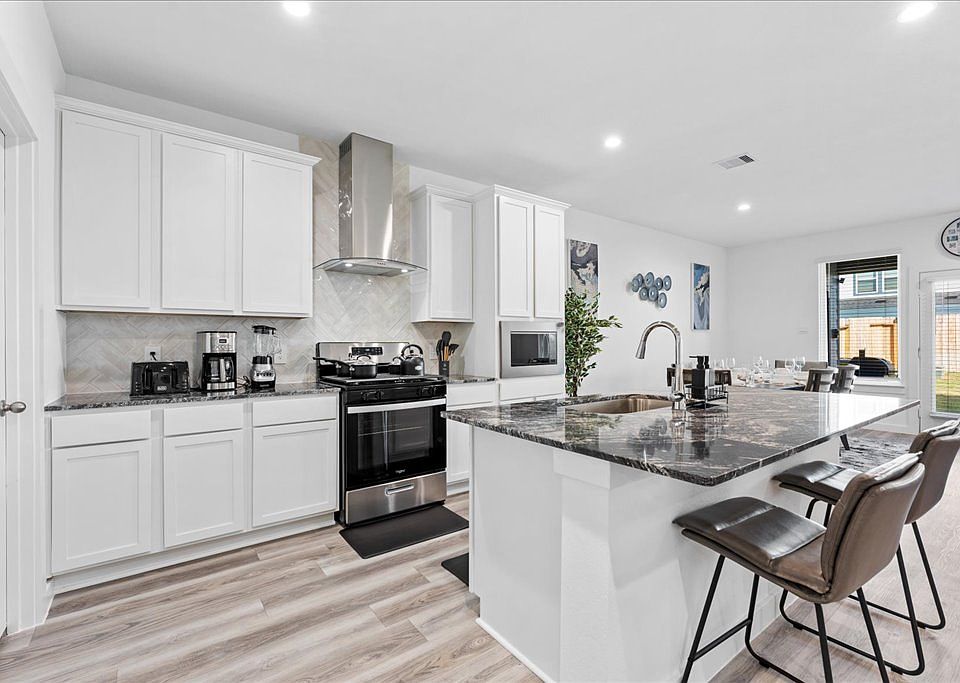 Kitchen with appliances and utensils