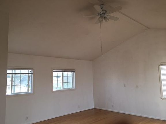High beamed ceiling, opening to small balcony.