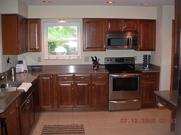 Completely remodeled kitchen with wood cabinets and quartz counters