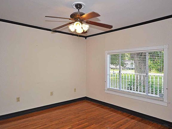 Living room with hardwood floors and crown molding.