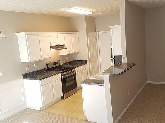 Bright open kitchen with newer stainless steel appliances. Easy access with groceries directly from the garage.